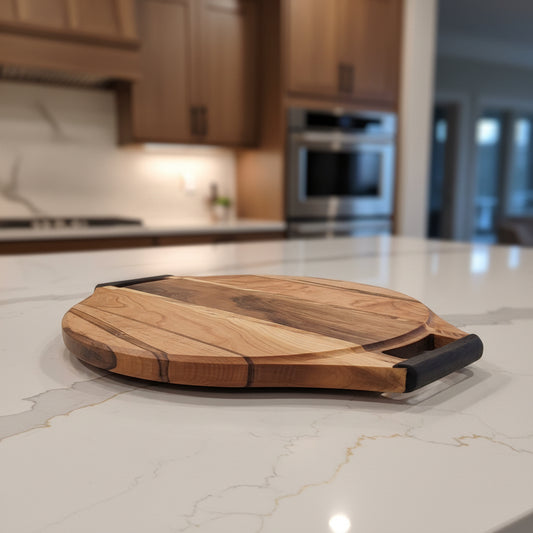 A round wooden cutting board with a natural wood grain pattern and a Wenge handle, resting on a white metal stand against a white fabric background.