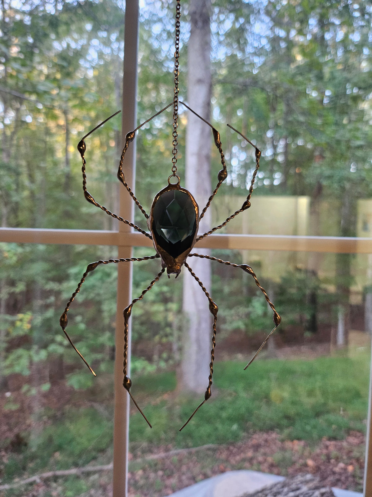Alternate view of The Silver Weaver, a black glass prism spider with hand-twisted copper wire legs in natural silver solder
