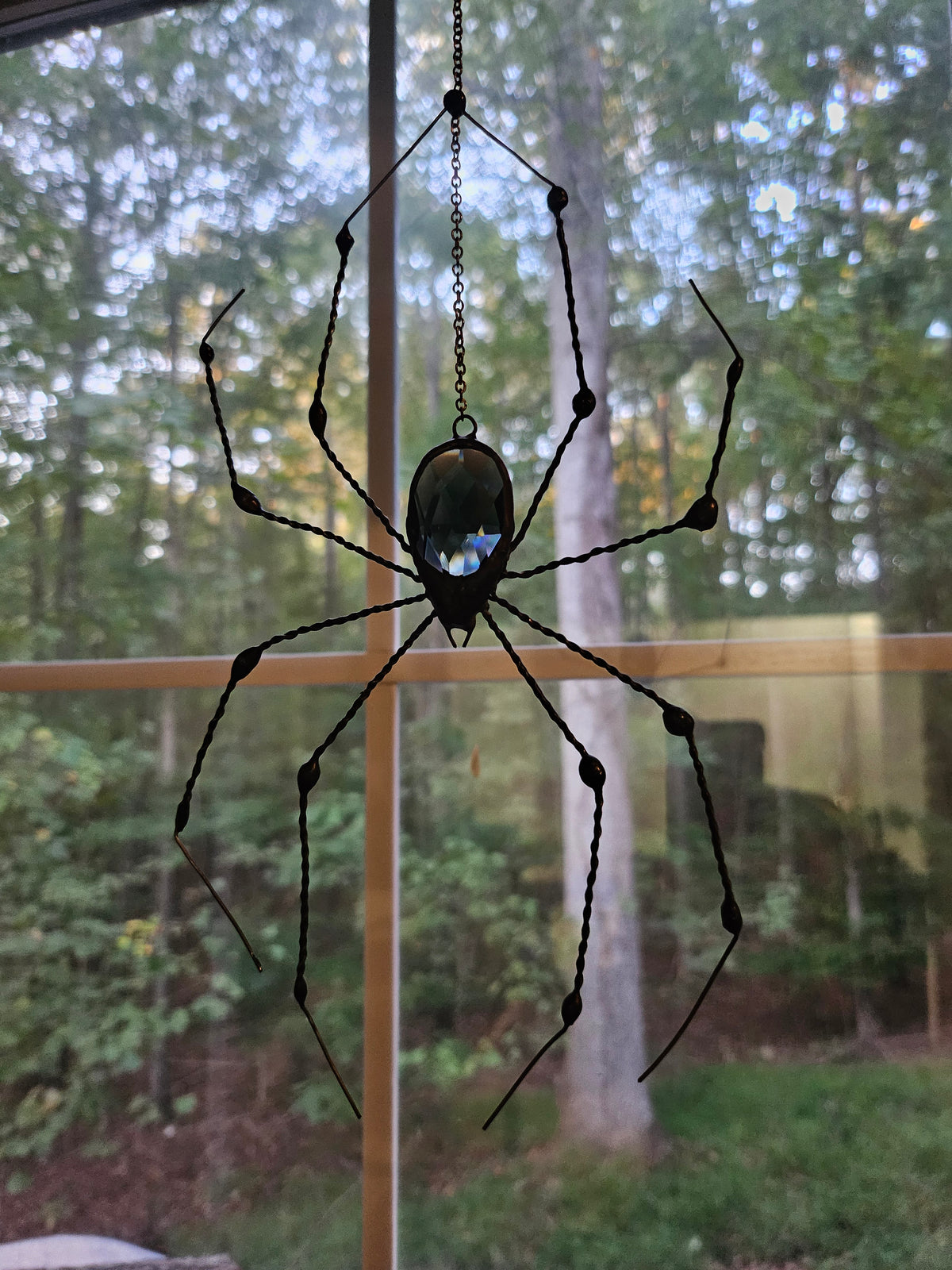 Alternate view of The Midnight Weaver, a black glass prism spider with hand-twisted copper wire legs finished in black patina